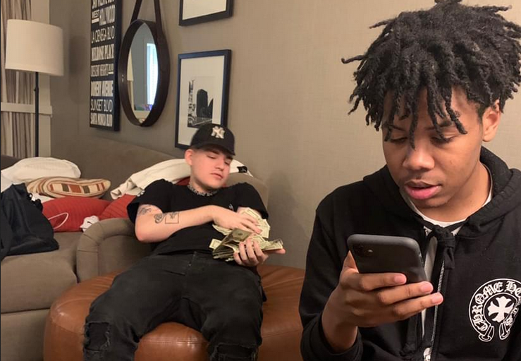 KanKan looking at his phone while hanging out with his rapper friend